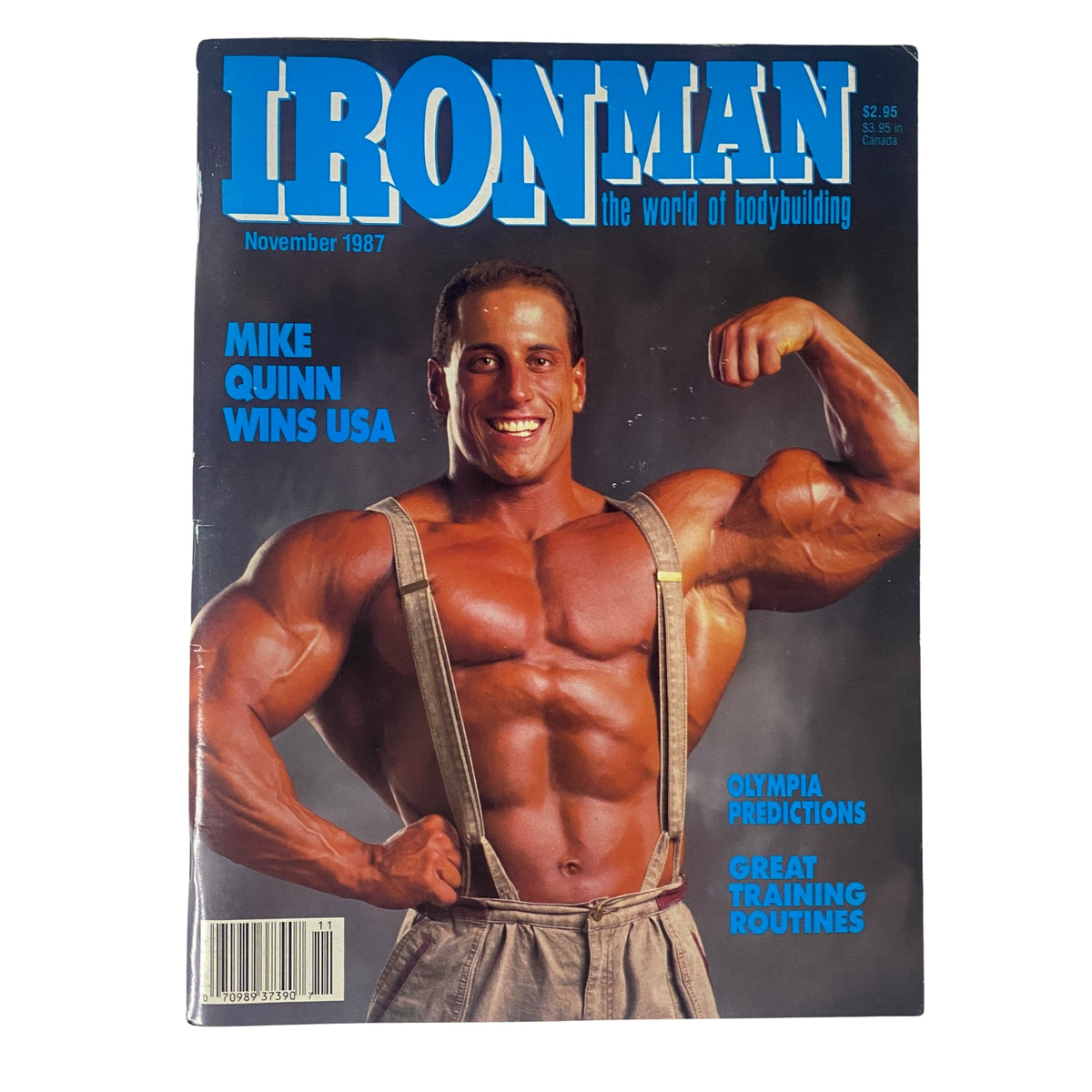 IronMan Magazine November 1987 featuring Mike Quinn on the cover. The magazine highlights Quinn's victory at the USA Championships and includes insights on bodybuilding, training routines, and predictions for the Olympia.