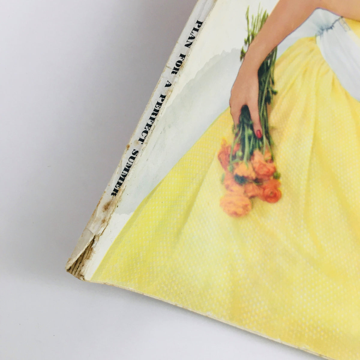 Side view of the VTG Seventeen Magazine June 1957, displaying the text 'Plan for a Perfect Summer' and the vibrant yellow imagery representative of 1950s fashion.