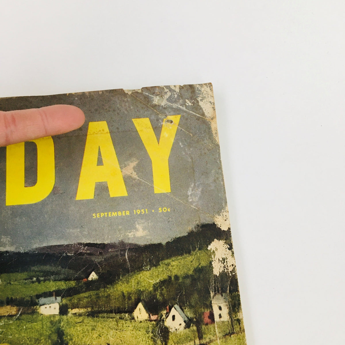 Detailed view of the top edge of the VTG Holiday Magazine September 1951, showing the title 'HOLIDAY' and signs of aging.