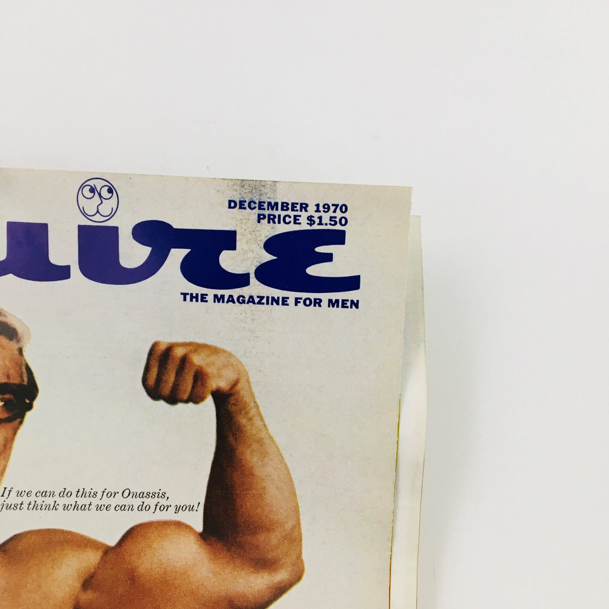 Close-up of the Esquire Magazine December 1970 cover featuring a muscular man with glasses, emphasizing the title and the special issue theme 'The Pursuit of Happiness!'. Vintage magazine cover image.
