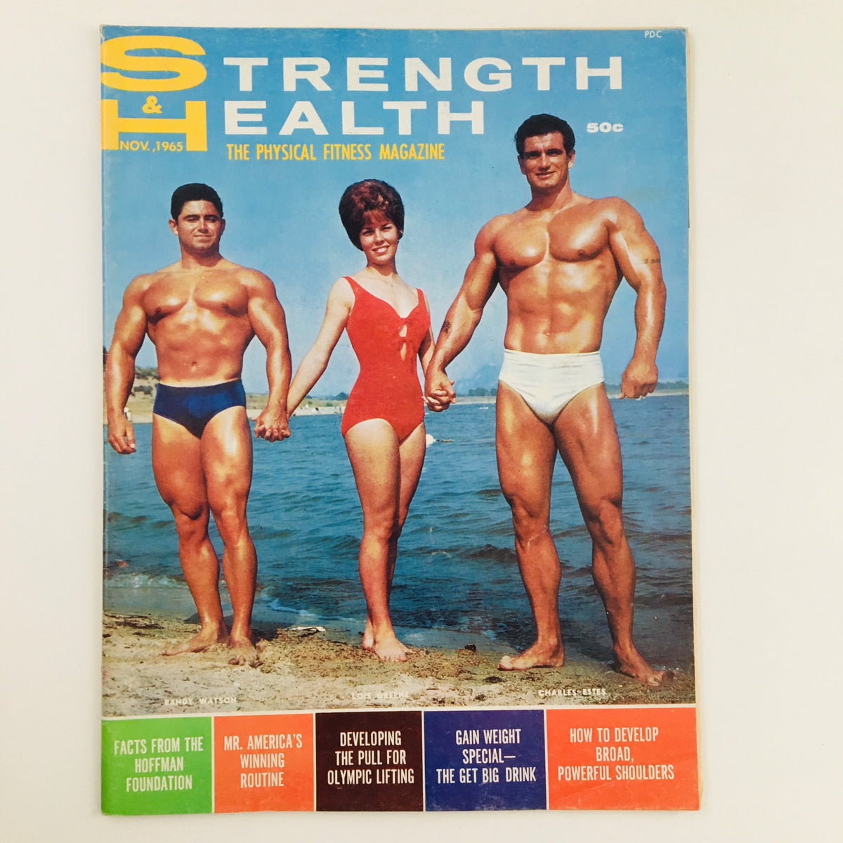 Cover of Strength & Health Magazine, November 1965 featuring Randy Watson and Lois Greene. The magazine highlights fitness culture with vibrant graphics and vintage style.