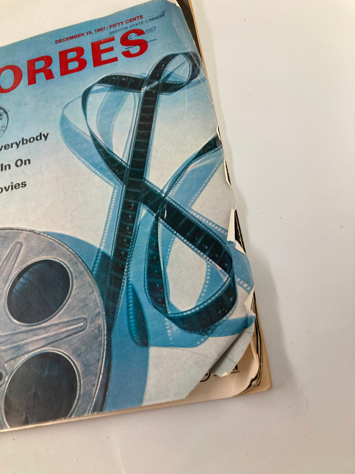 Close-up image of the cover of VTG Forbes Magazine December 15, 1967, highlighting the film reel design and the title 'Why Everybody Wants In On The Movies'.