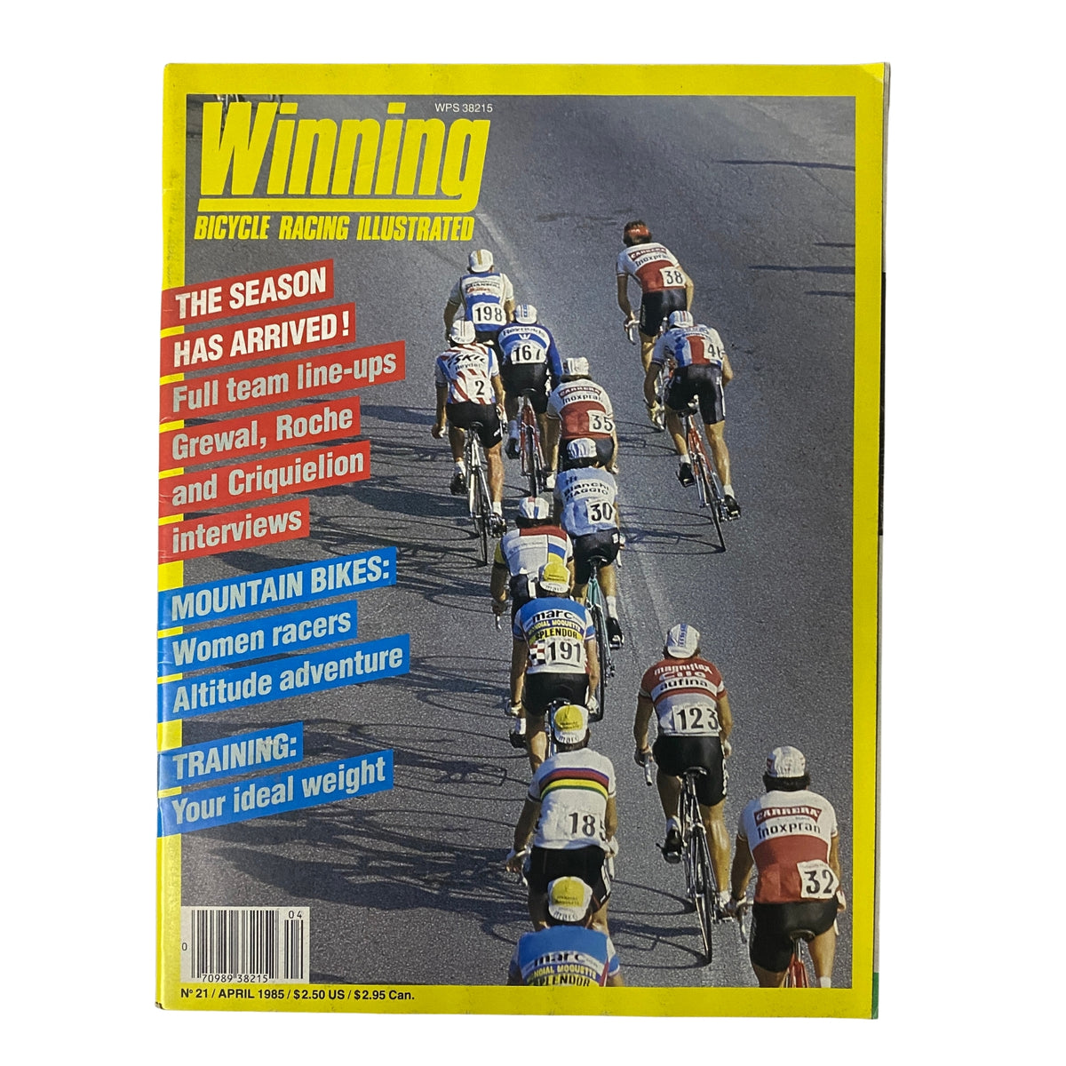 Cover of Winning Bicycle Racing Illustrated, April 1985, No. 21, featuring a group of cyclists in a racing line. The title emphasizes the arrival of the cycling season, with articles on mountain bikes, women racers, and training tips.