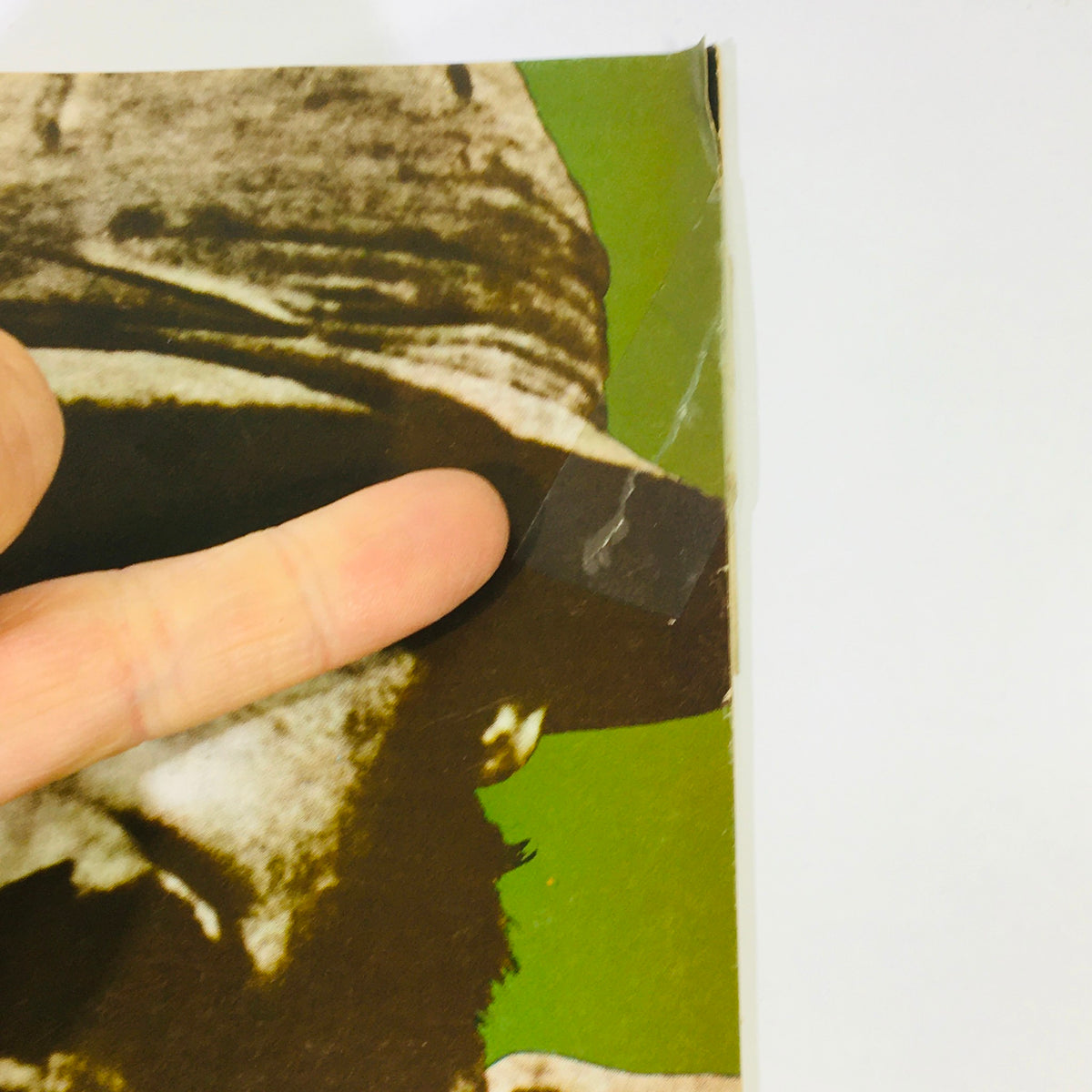 Close-up image of the edge of the VTG History of the Second World War Part 47 1974 - Wingate Minus the Myth magazine, showing minor wear and a finger pointing at a small rip.