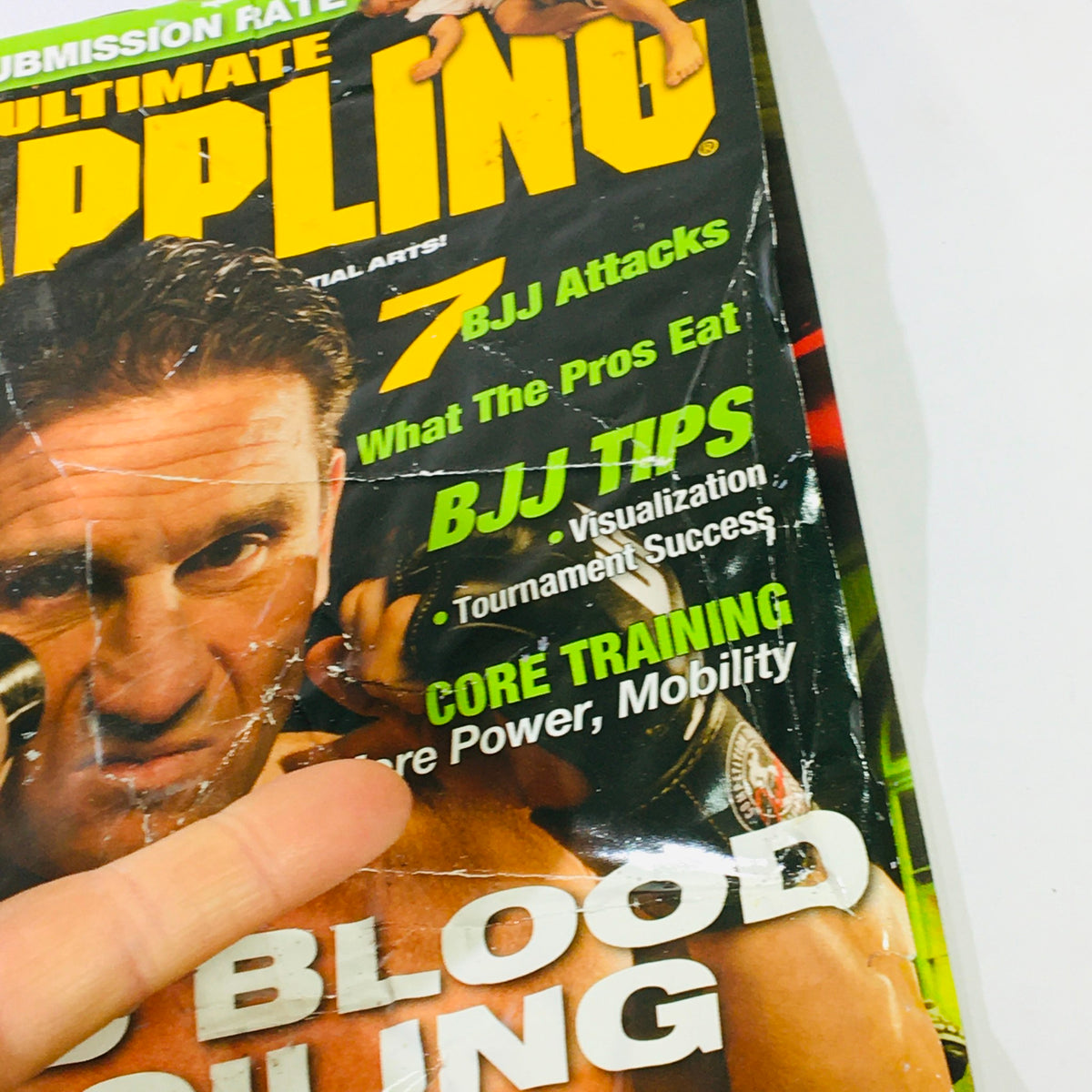 Detailed view of the Ultimate Grappling MMA Magazine August 2006 including text about BJJ attacks and training tips.