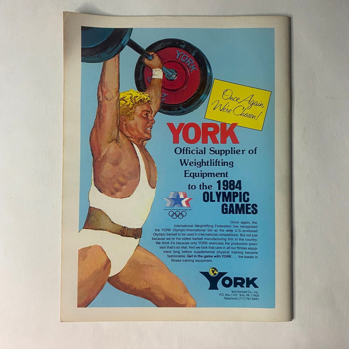 Advertisement for York, Official Supplier of Weightlifting Equipment for the 1984 Olympic Games, from Strength & Health Magazine July 1984.