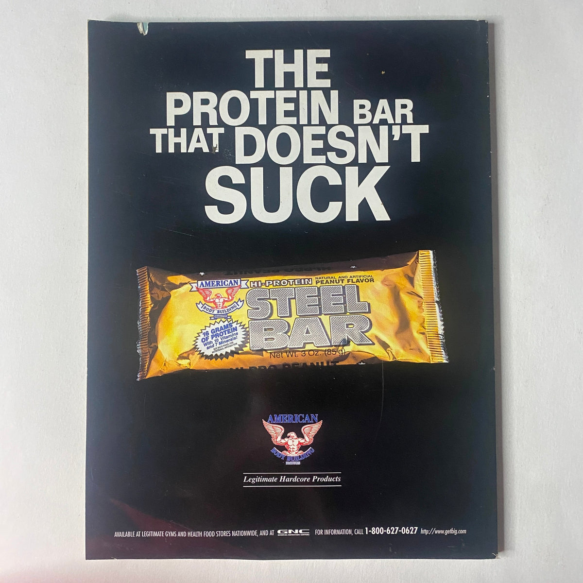 Advertisement for American bodybuilding product featuring the Steel Bar, described as 'The Protein Bar That Doesn't Suck', from IronMan Magazine September 1996.