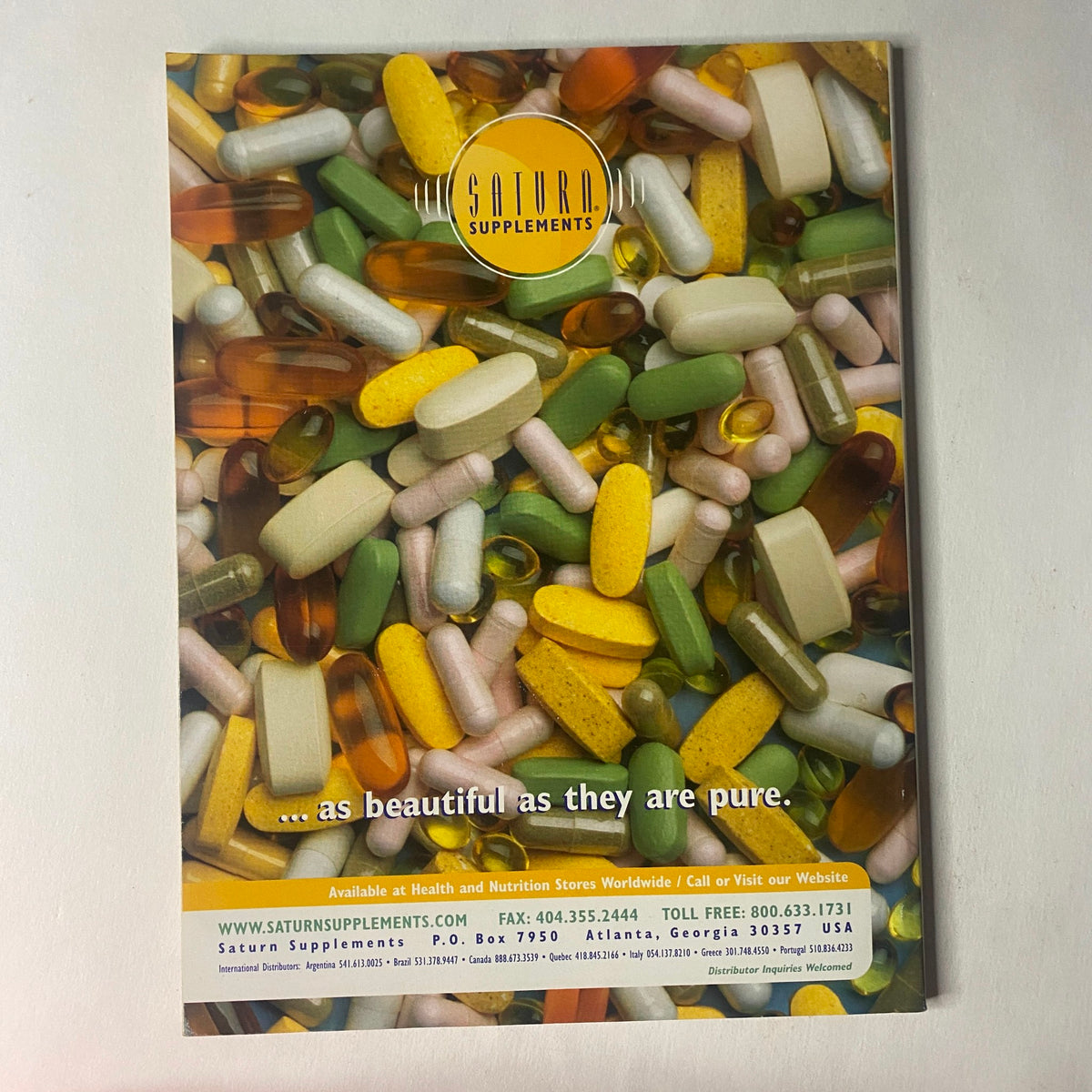 Ad for Saturn Supplements on the back of IronMan Magazine November 1999 showcasing a variety of vitamins and supplements with the slogan '...as beautiful as they are pure.'