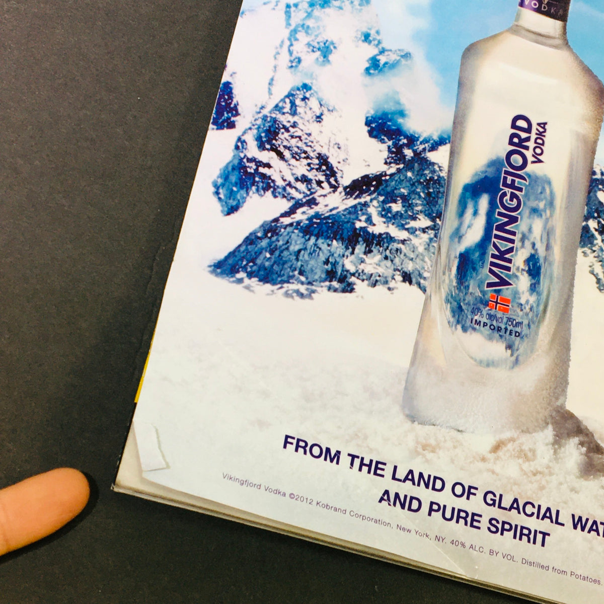 Promotional content from Maxim Magazine September 2012 for Vikingfjord Vodka, featuring scenic imagery.