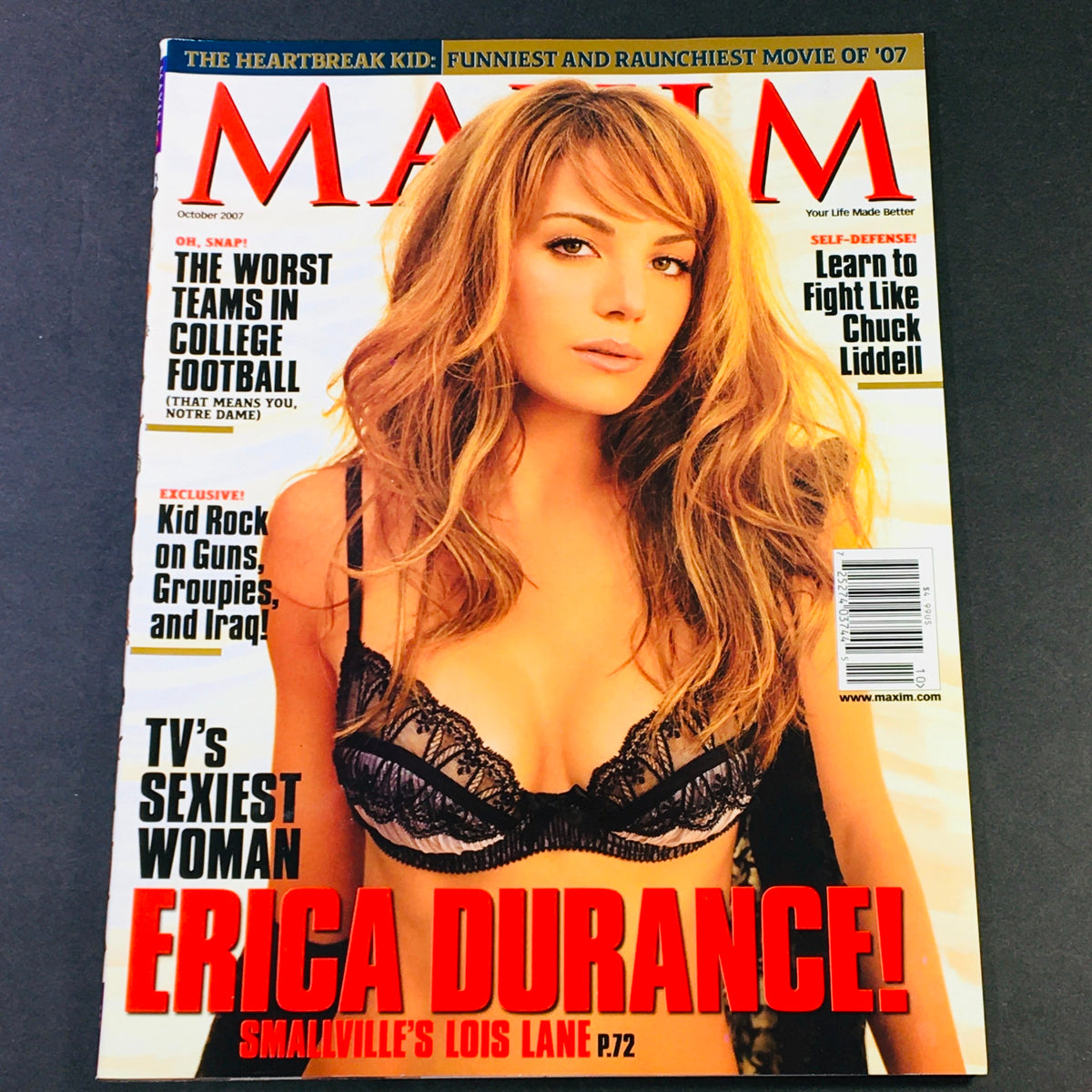 Maxim Magazine October 2007 cover featuring Erica Durance as Smallville's Lois Lane, showcasing her in a stylish black lingerie outfit, reflecting the magazine's theme of beauty and pop culture.