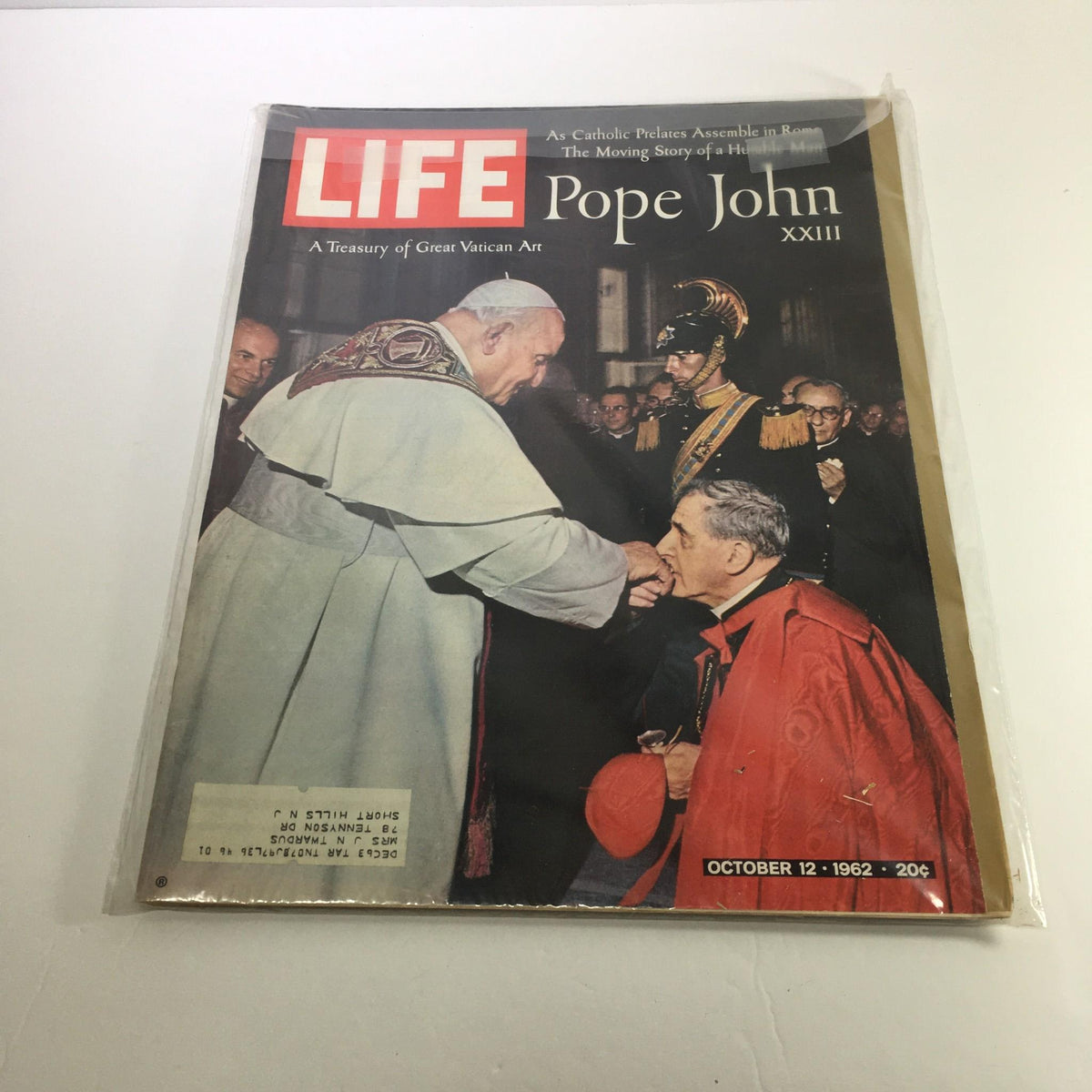 Cover of Life Magazine from October 12, 1962 featuring Pope John XXIII. The image depicts Pope John XXIII greeting an individual, surrounded by attendees in formal attire, highlighting the theme 'A Treasury of Great Vatican Art.' This cover encapsulates a significant moment in Vatican history during the early 1960s.