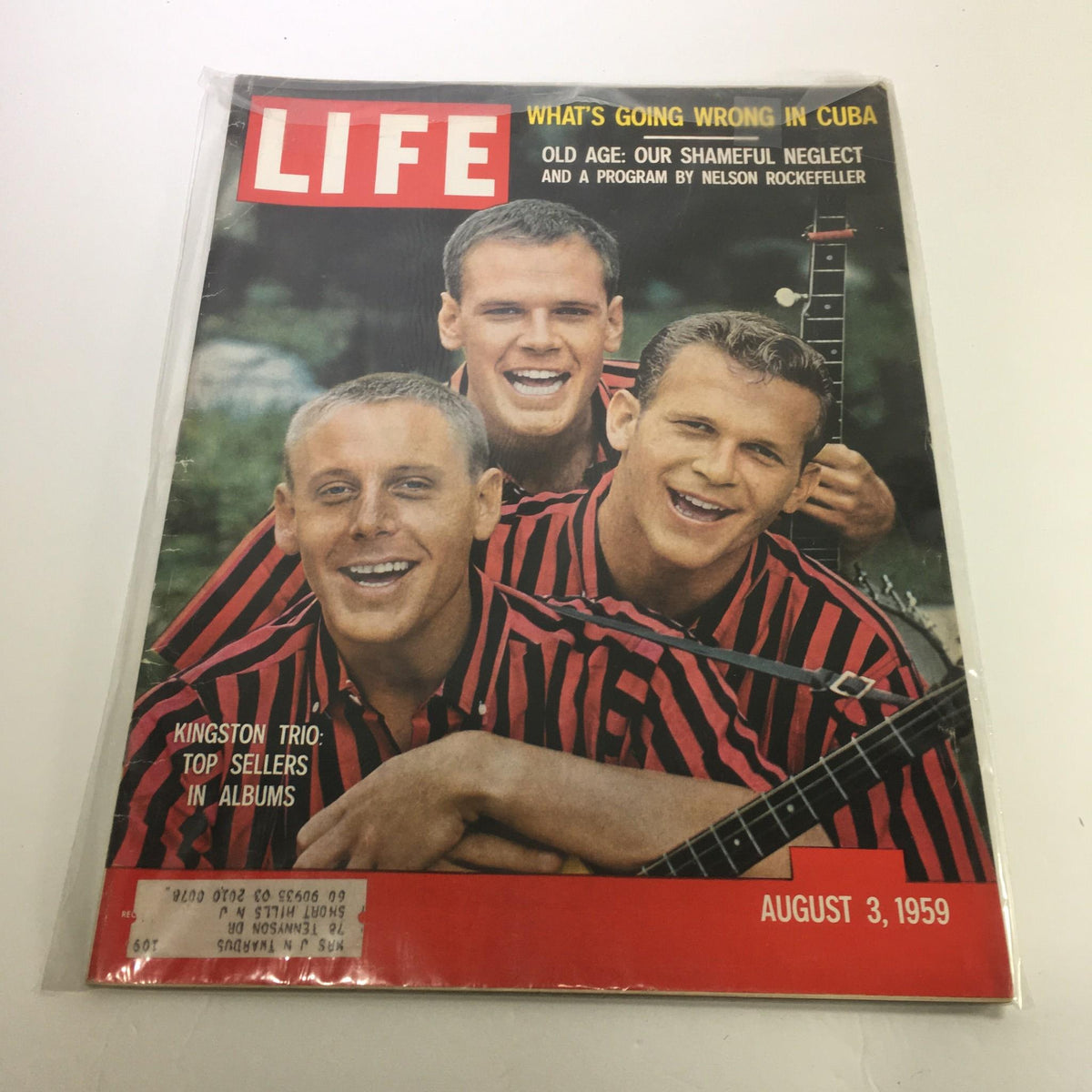 Cover of VTG Life Magazine dated August 3, 1959, featuring The Kingston Trio, highlighting their status as top sellers in albums, with a vibrant image of the trio in striped shirts and musical instruments.