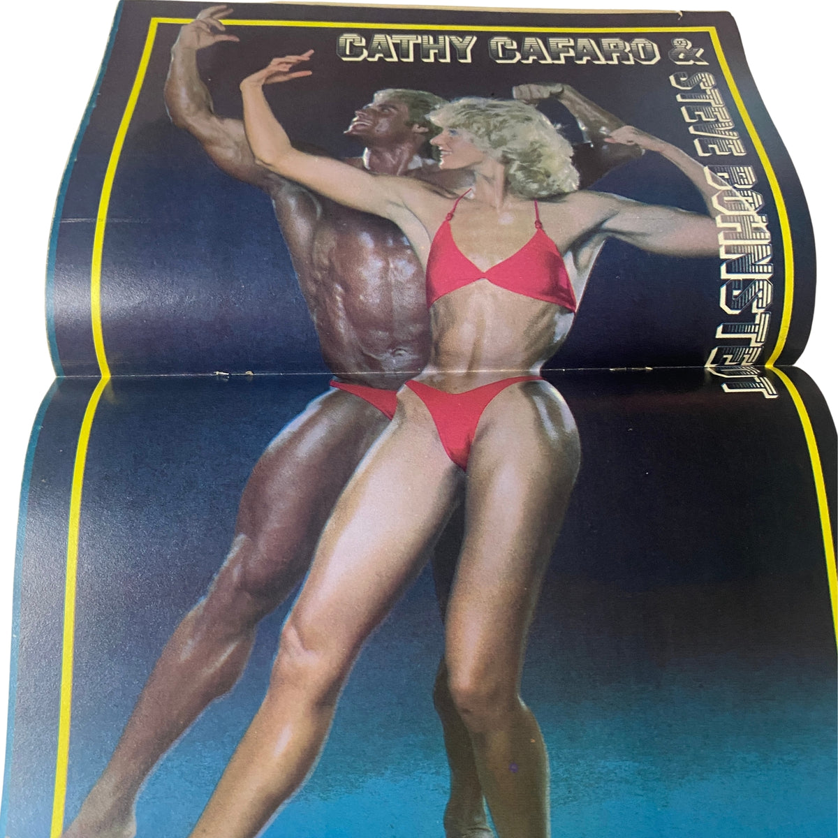 Centerfold featuring Cathy Cafaro and a male bodybuilder from Muscle & Bodybuilder Magazine July 1984.