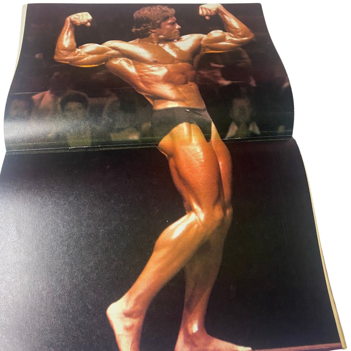 Centerfold image from Muscle World Magazine May 1981 Vol 2 No. 5 showing Richard Baldwin flexing his muscles on stage, highlighting his impressive physique during a bodybuilding competition.