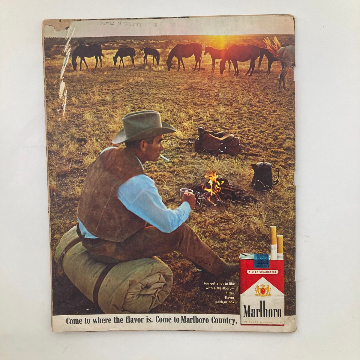 Back cover of VTG Look Magazine December 13 1966 showcasing a Marlboro advertisement, depicting a cowboy by a campfire, capturing the essence of 1960s Americana.