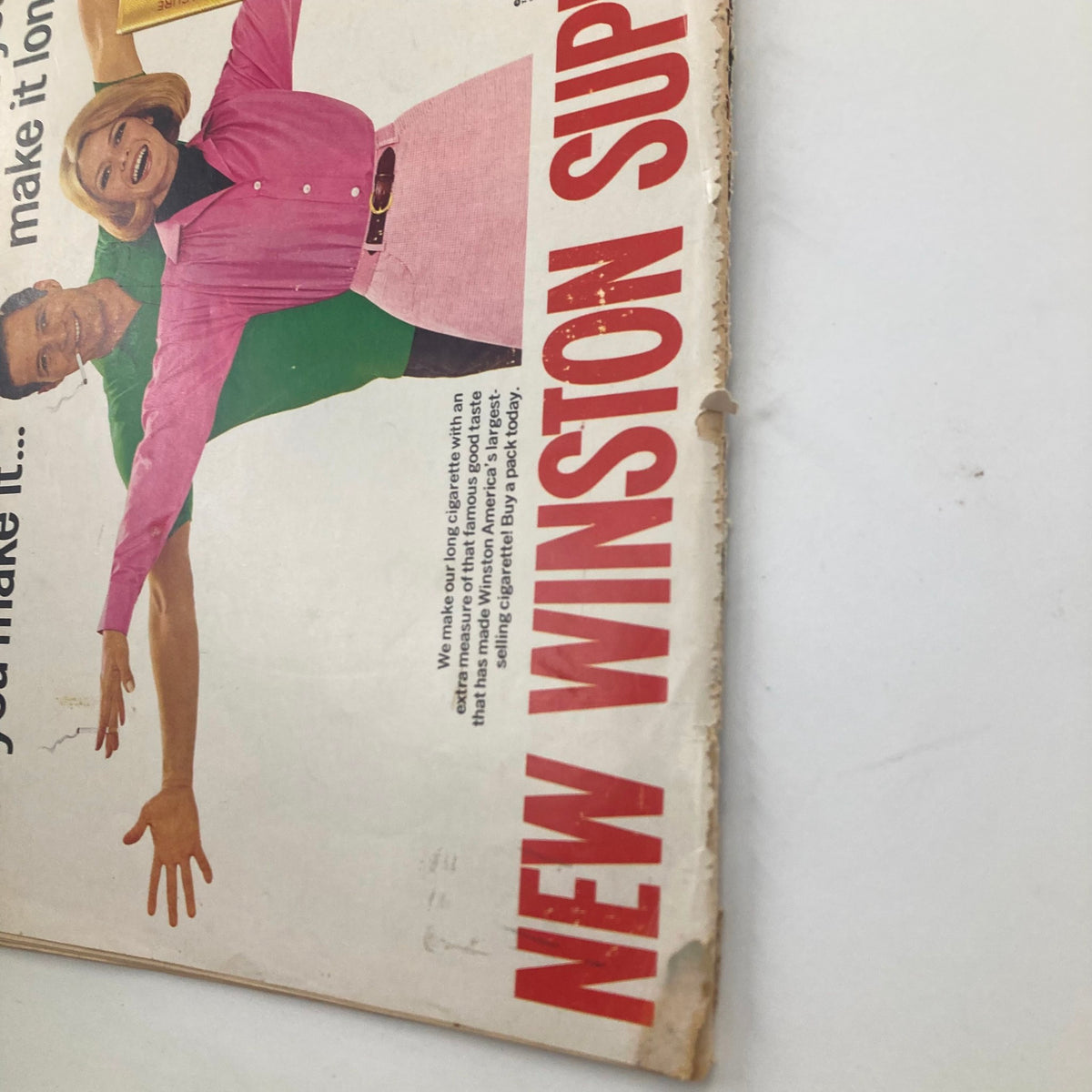 Close-up of a vintage advertisement featuring a couple promoting Winston Super Kings cigarettes, highlighting the catchy tagline and vibrant colors, from the VTG Look Magazine August 22, 1967 Vol 31 No. 17 Moshe Dayan & Yael Dayan.