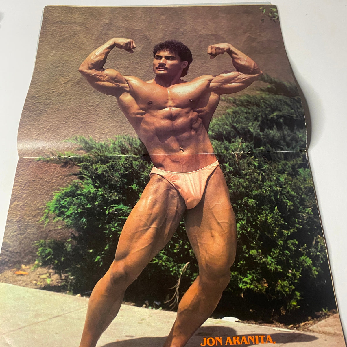 Centerfold of Jon Aranita from Muscle Digest Magazine June 1984 showcasing impressive bodybuilding physique. The image highlights his muscular structure and competitive stance.