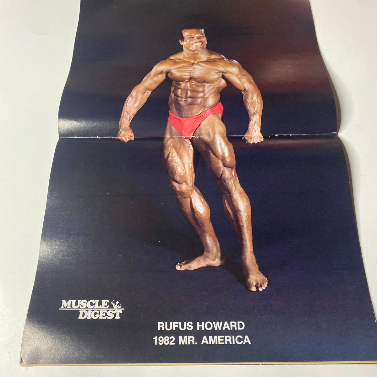Muscle Digest Magazine January 1983 featuring Rufus Howard, the 1982 Mr. America, displayed in a centerfold showcasing his physique. The image emphasizes muscle definition and bodybuilding aesthetics.
