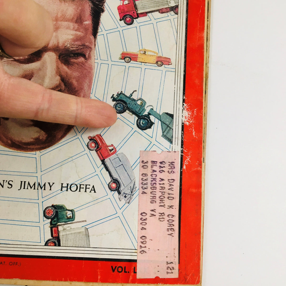 Close-up of Time Magazine September 9, 1957 cover showing Teamster Union's Jimmy Hoffa with a finger pointing at vehicles on the page, highlighting the magazine's vintage label.