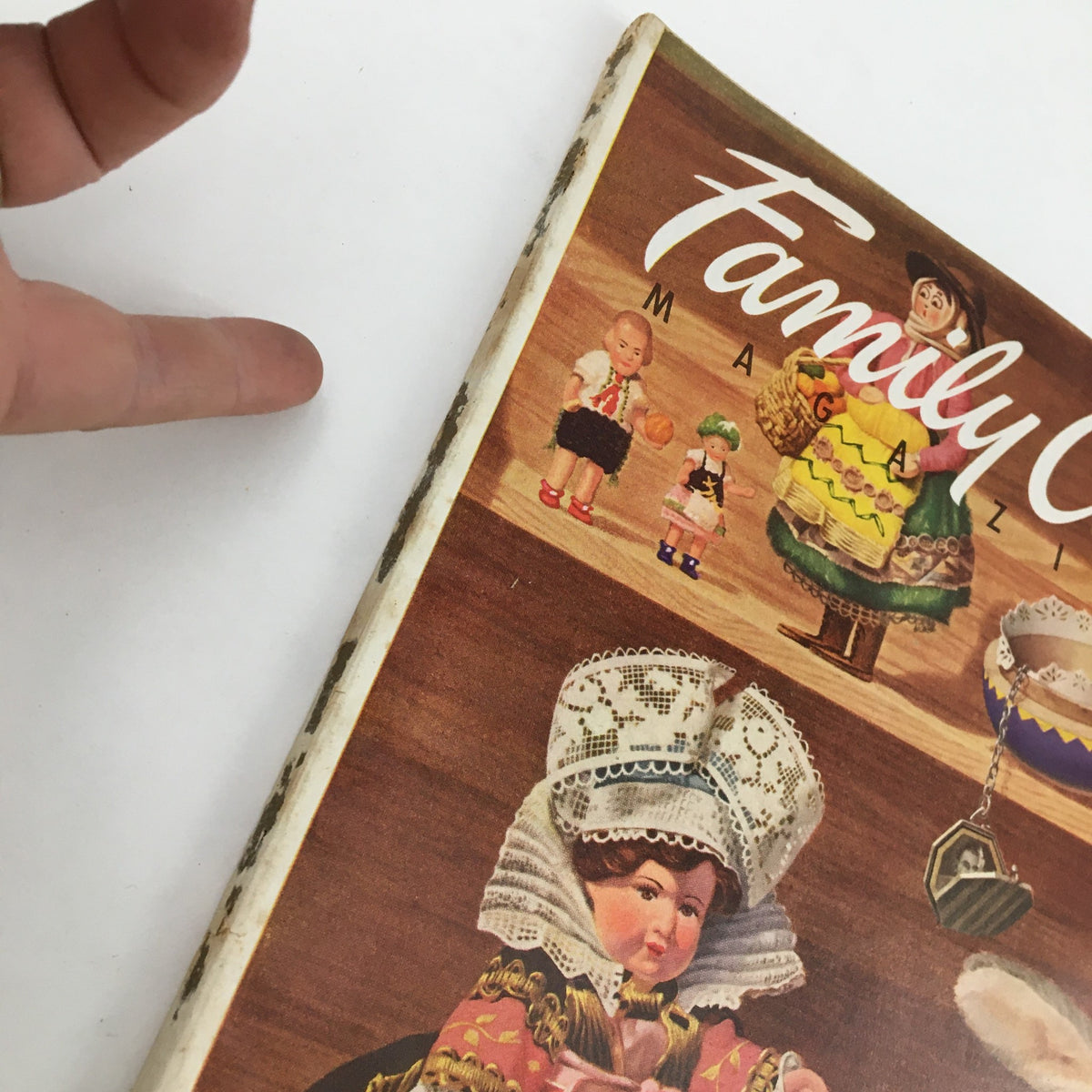 Side view of Family Circle Magazine April 1954 showing minor wear and vintage details, highlighting its collectible nature and historical significance.
