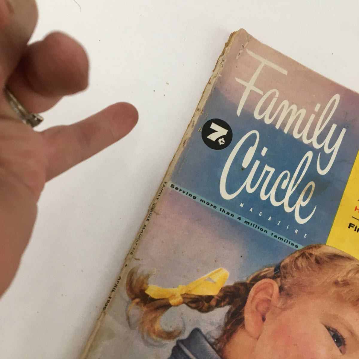 Close-up of the Family Circle Magazine April 1956 cover, illustrating the magazine title and highlighting the girl's hairstyle and the puppy.