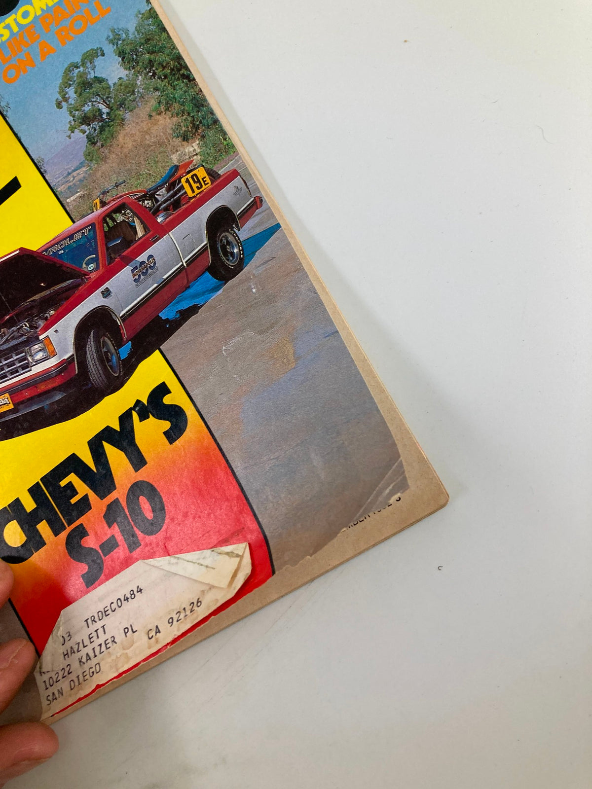 Side view of the VTG Truckin Magazine December 1982 highlighting the title 'Chevy's S-10' and showcasing the magazine's cover details featuring dual axle trucks and the Reno F-100 Nationals.