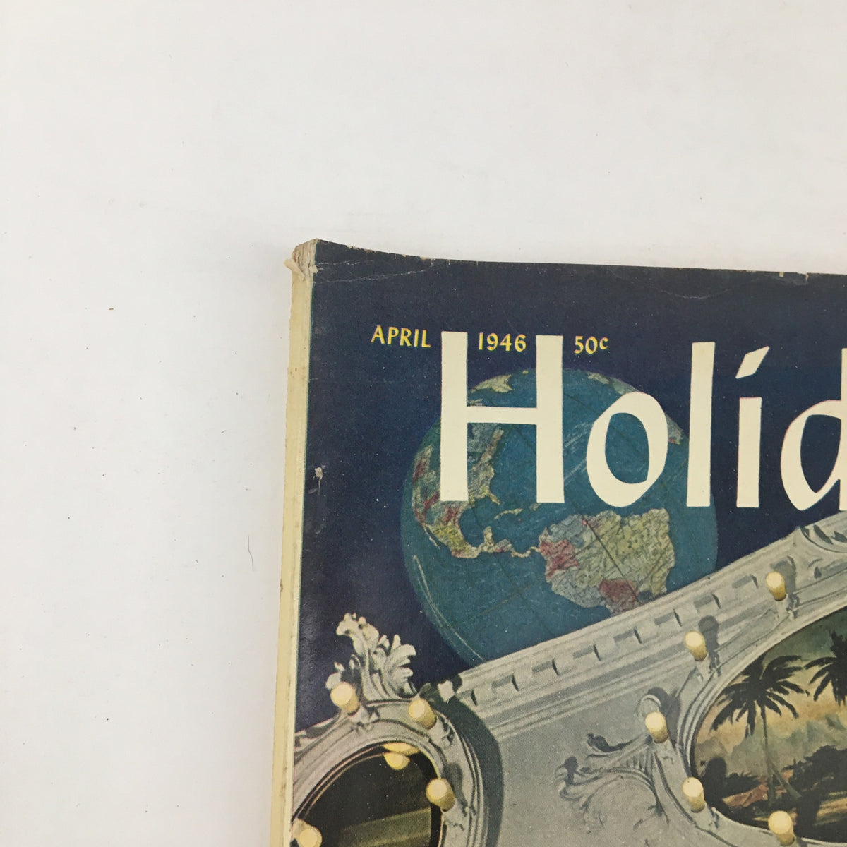 Close-up of the top section of Holiday Magazine April 1946 showcasing the title and date along with a portion of the vibrant cover design.