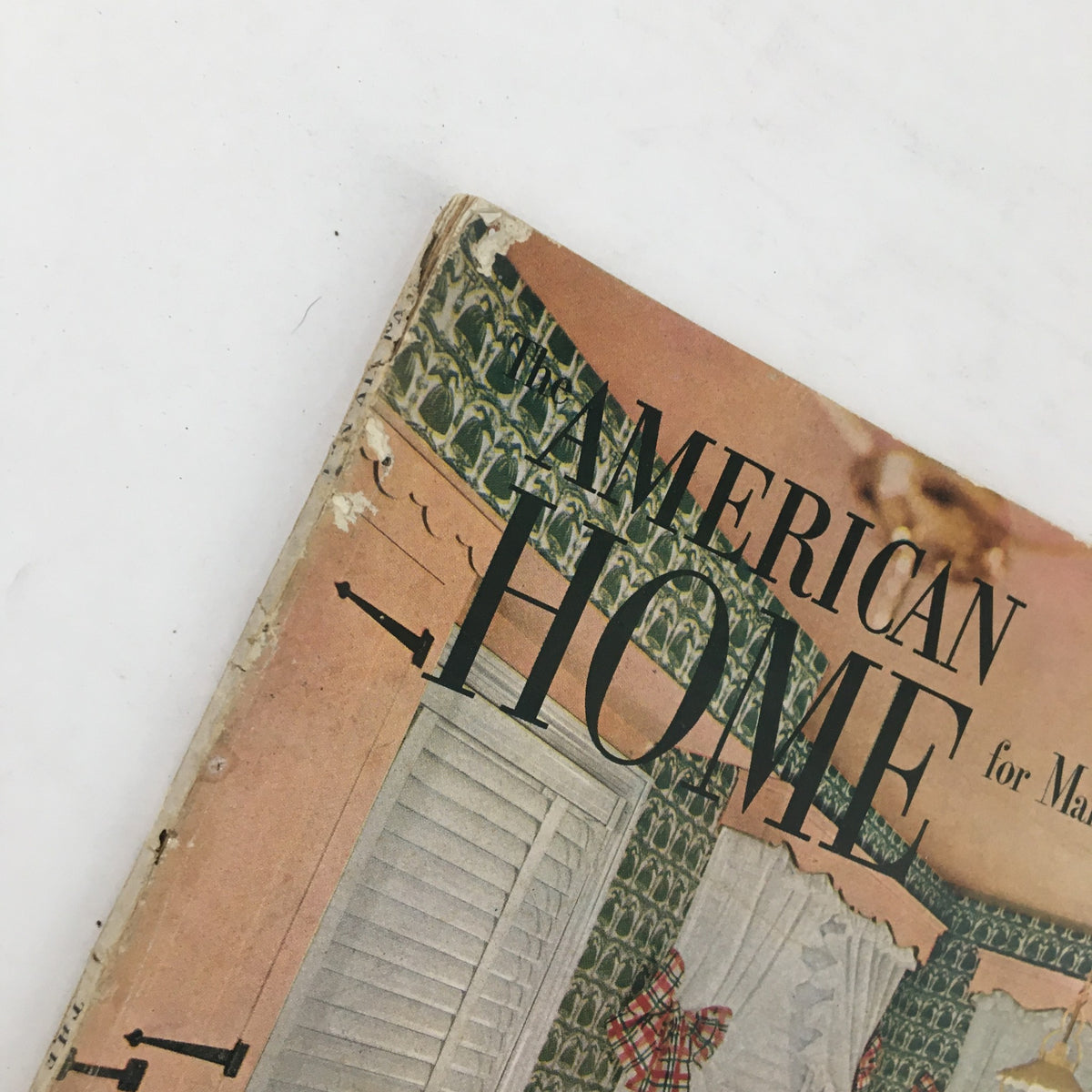 Close-up view of The American Home Magazine March 1951 cover, highlighting the vintage title and partial kitchen decor.
