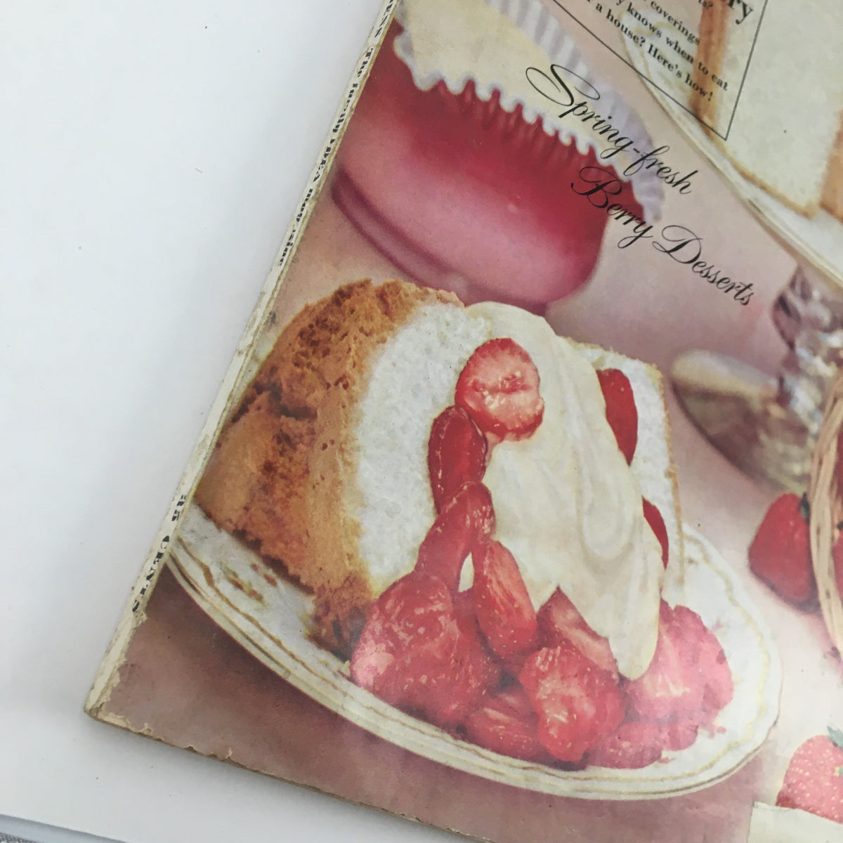 Close-up of the cover of Better Homes & Gardens May 1959 emphasizing a dessert of strawberries and cream on a plate, featuring retro aesthetic and gardening elements.