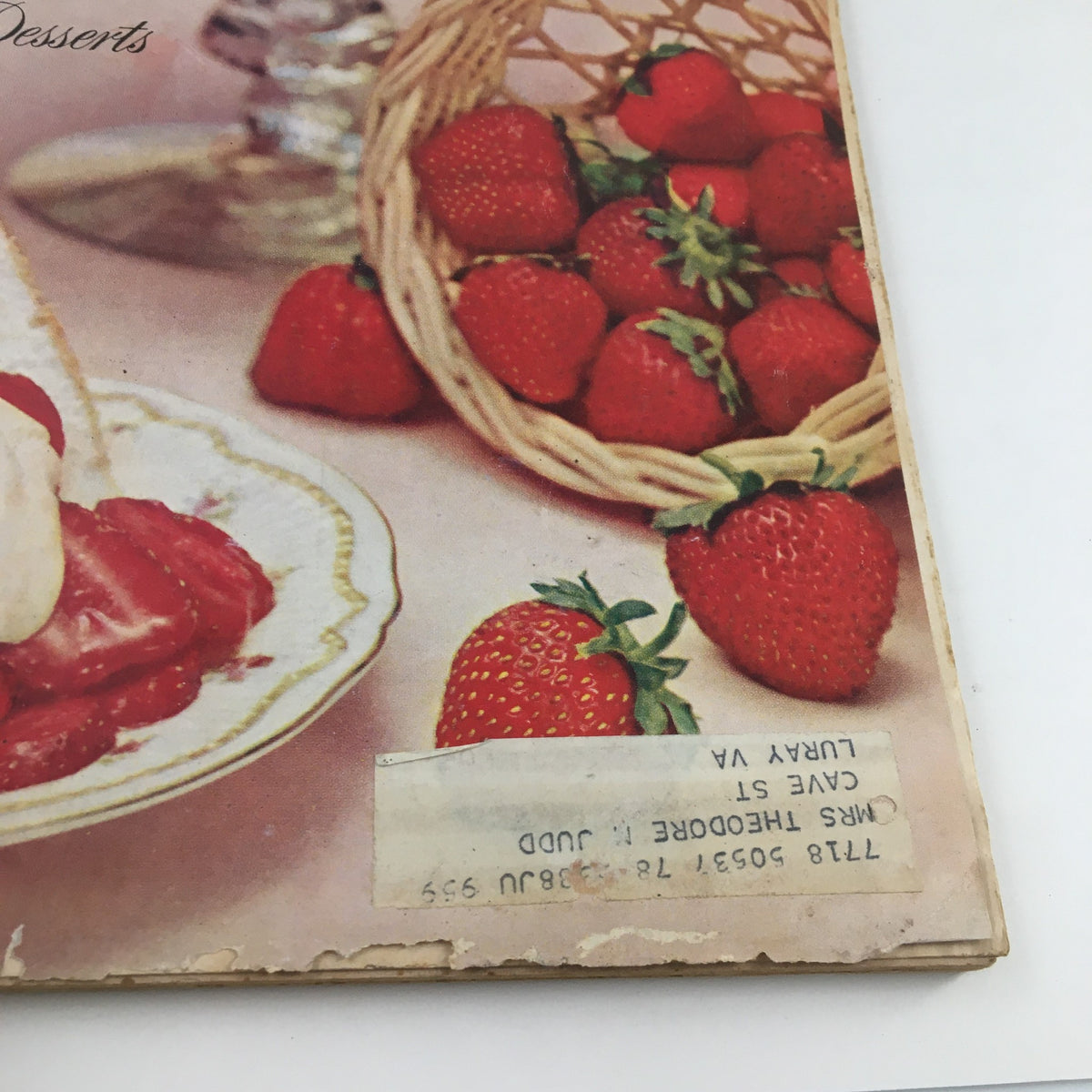 Delicious dessert featuring strawberries and ice cream, on a plate and with a basket of fresh strawberries, featured in Better Homes & Gardens May 1959 Flower Containers of Distinction and Beauty.
