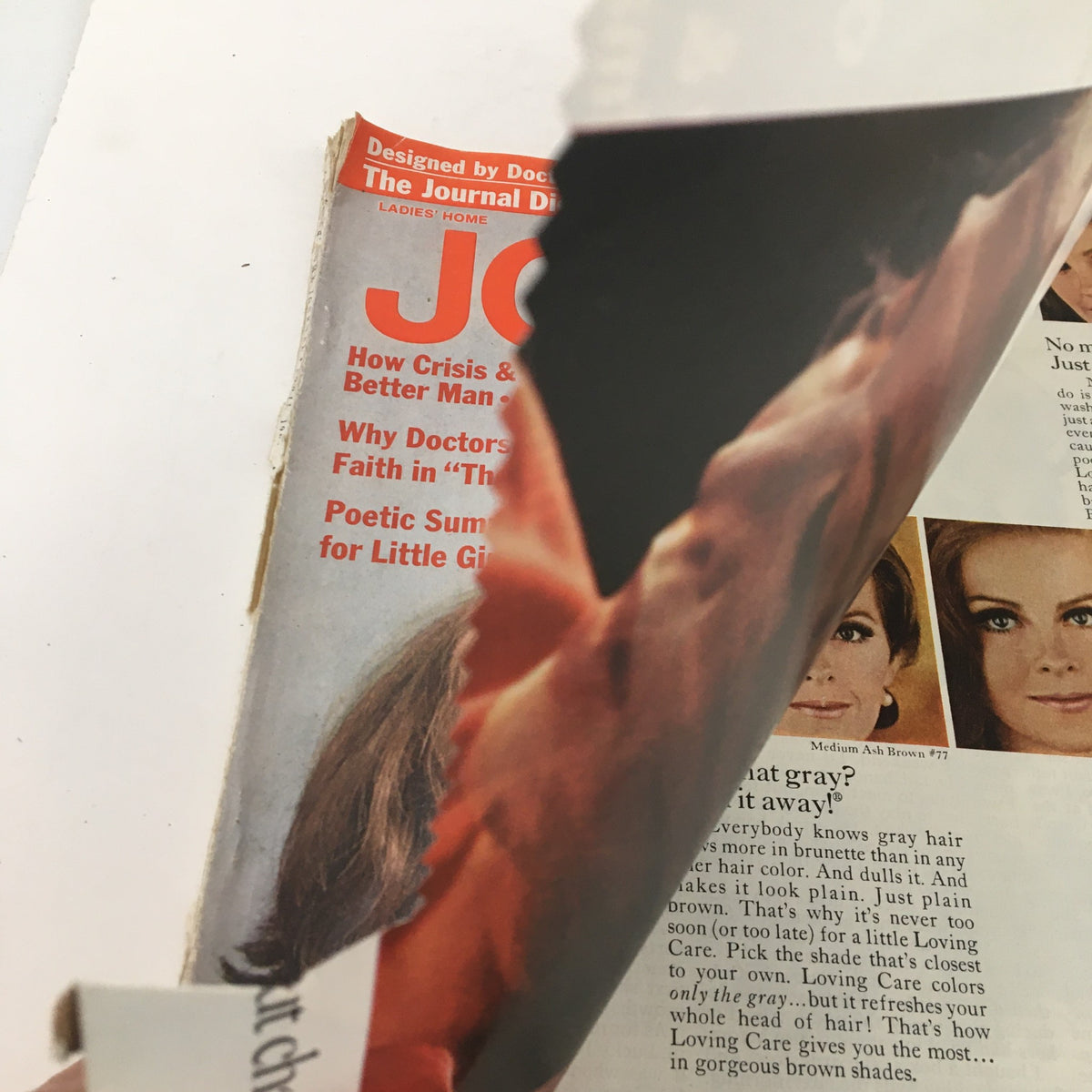 Side view of the Ladies' Home Journal Magazine April 1969, showing part of the magazine's cover, featuring various articles and a promotional section for Loving Care hair products.