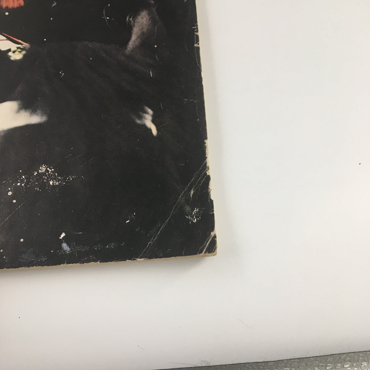 Close-up of the bottom edge of the damaged cover of Holiday Magazine April 1956 titled 'William Shakespeare's Raffish London', highlighting scuff marks.
