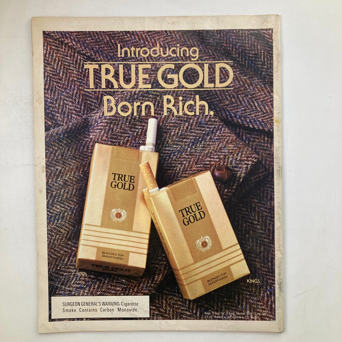 Advertisement for True Gold cigarettes in VTG Life Magazine February 1986, demonstrating the era's advertising trends.