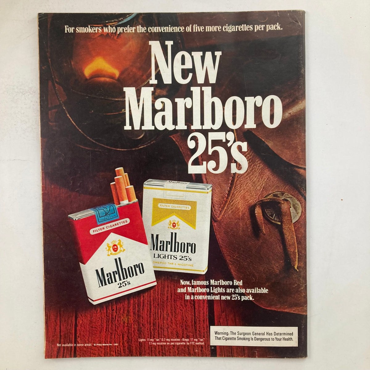 Ad for New Marlboro 25's featured in VTG Life Magazine March 1985, showcasing cigarette packaging and promotional information.