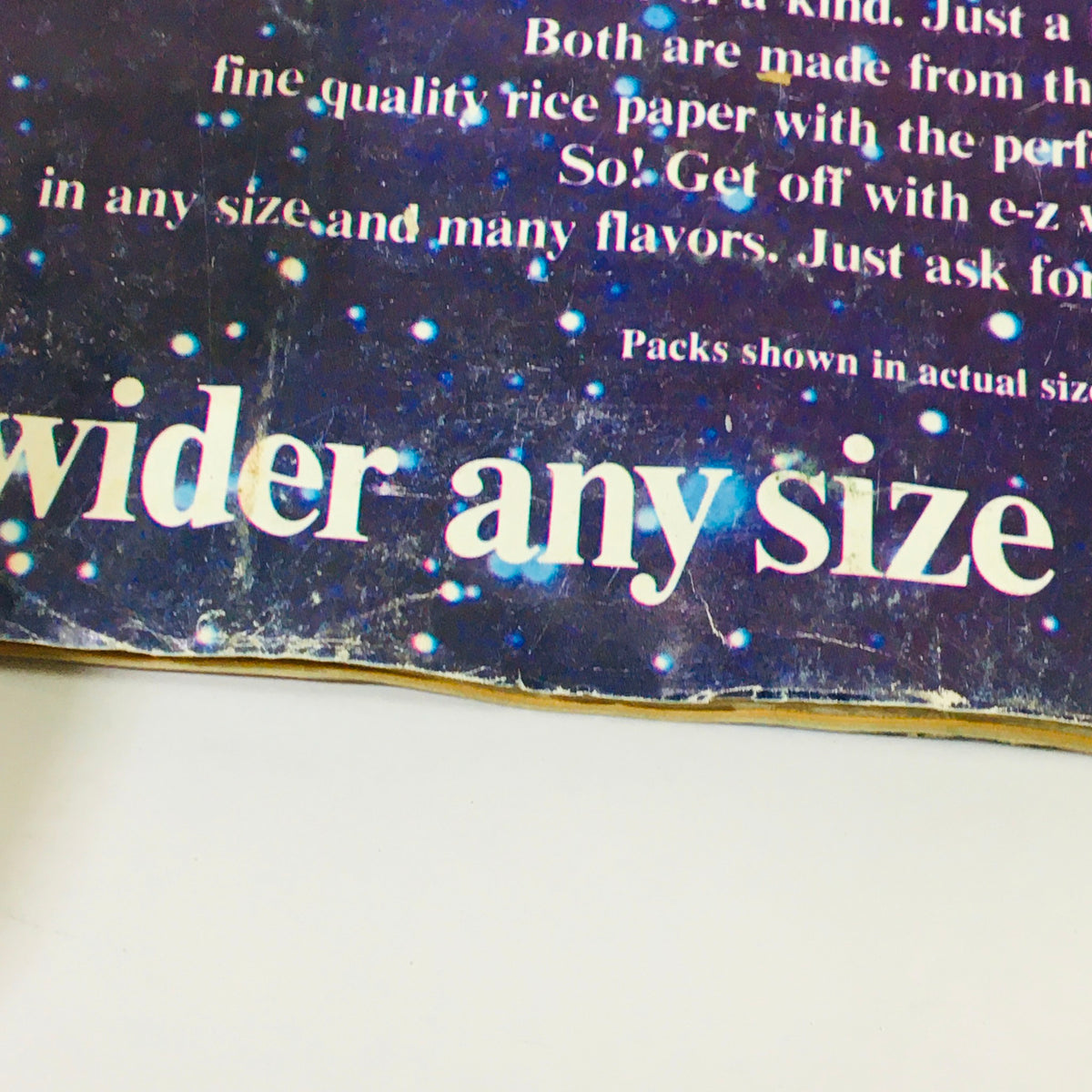 Close-up shot of the back cover of VTG High Times Magazine May 1978 highlighting an advertisement for rolling papers, focusing on the text 'wider any size'.