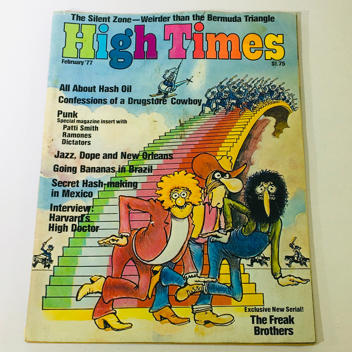 Cover of the February 1977 issue of High Times magazine featuring cartoon characters in colorful attire, promoting articles on hash oil, punk music, and notable artists like Patti Smith, the Ramones, and Dictators.
