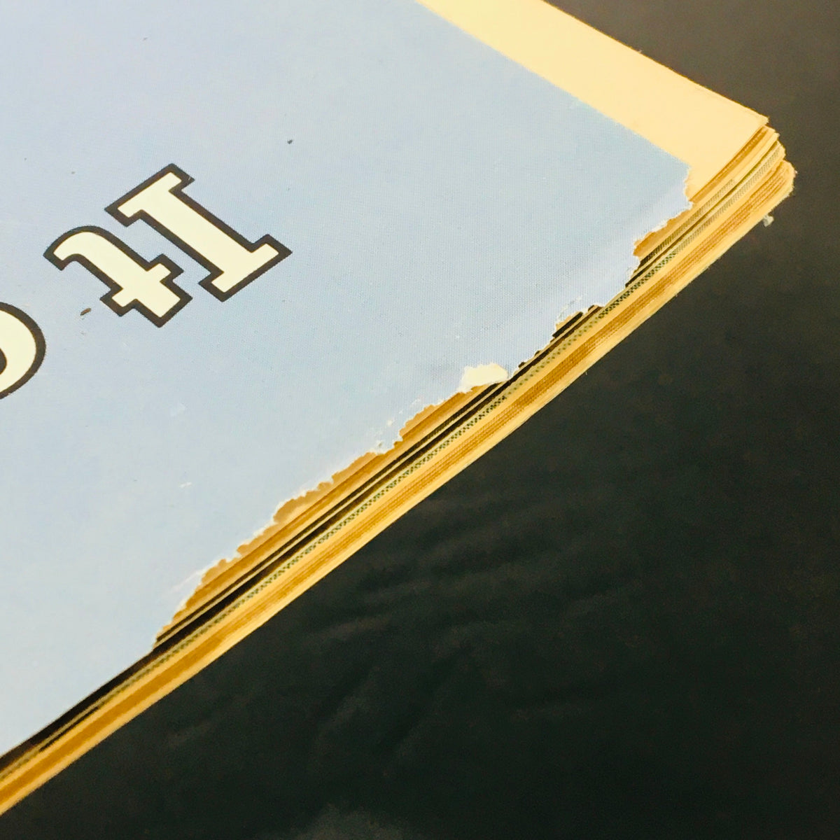 Side view of the VTG High Times Magazine Collector's Issue 1974, showcasing the torn edge and aged pages, reflecting its vintage condition.