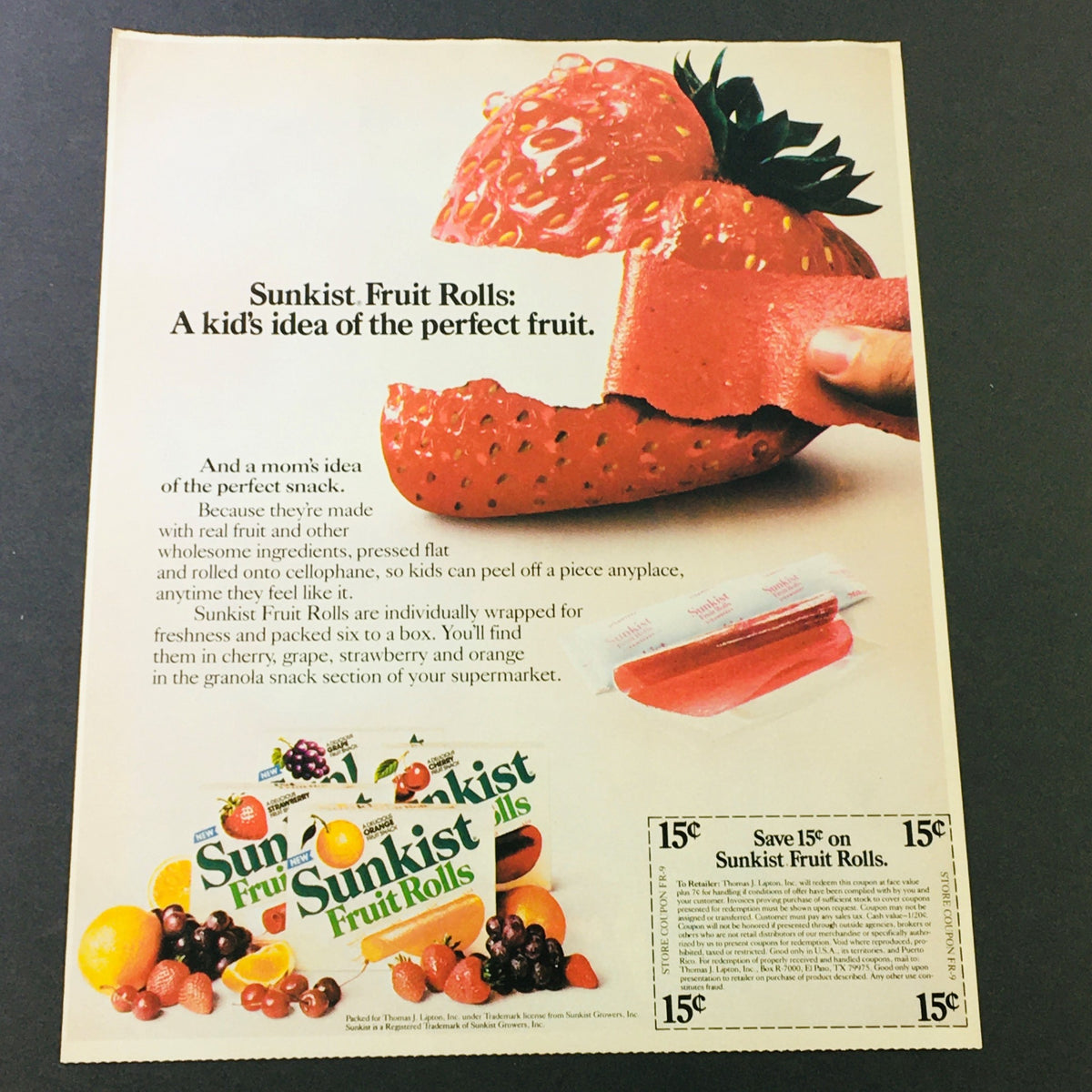 VTG Retro 1984 Sunkist Fruit Rolls Snack & Promise Toothpaste Discount Ad Coupon featuring Sunkist Fruit Rolls advertisement with a strawberry and colorful fruit display.