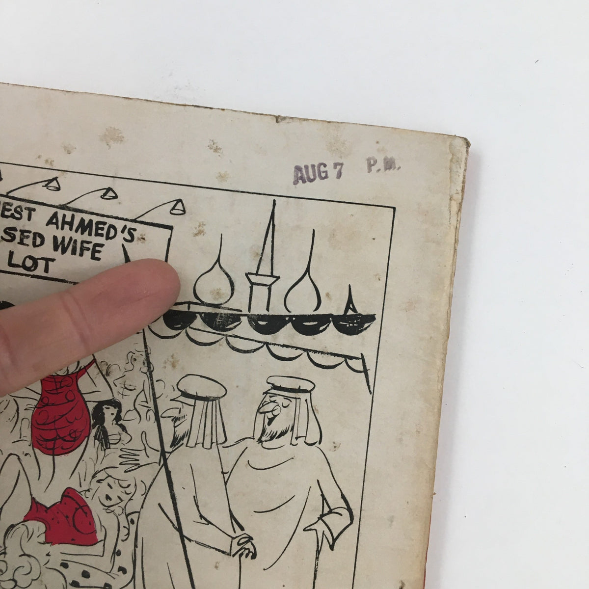 Close-up of the back cover of Dolls & Gags Magazine October 1958, featuring a hand pointing to illustrated characters and the stamped date 'AUG 7 P.M.' This vintage magazine showcases mid-century culture and humor.