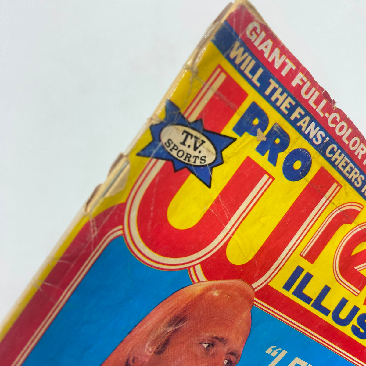 Close-up of the corner of Pro Wrestling Illustrated July 1985 showing the 'T.V. Sports' logo, emphasizing the magazine's broadcasting connection.