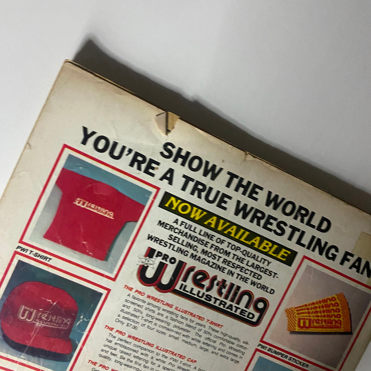 Back cover of Pro Wrestling Illustrated July 1985 showcasing merchandise advertisements including a T-shirt, cap, and bumper sticker, reflecting the vintage wrestling culture.