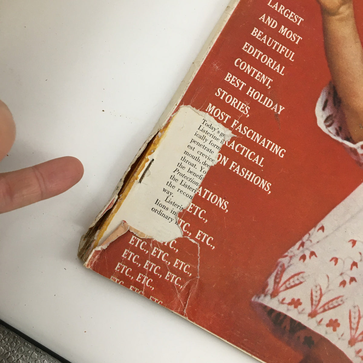 Close-up of the damaged spine area of McCall's Magazine December 1960, showcasing the wear and history of this vintage publication.