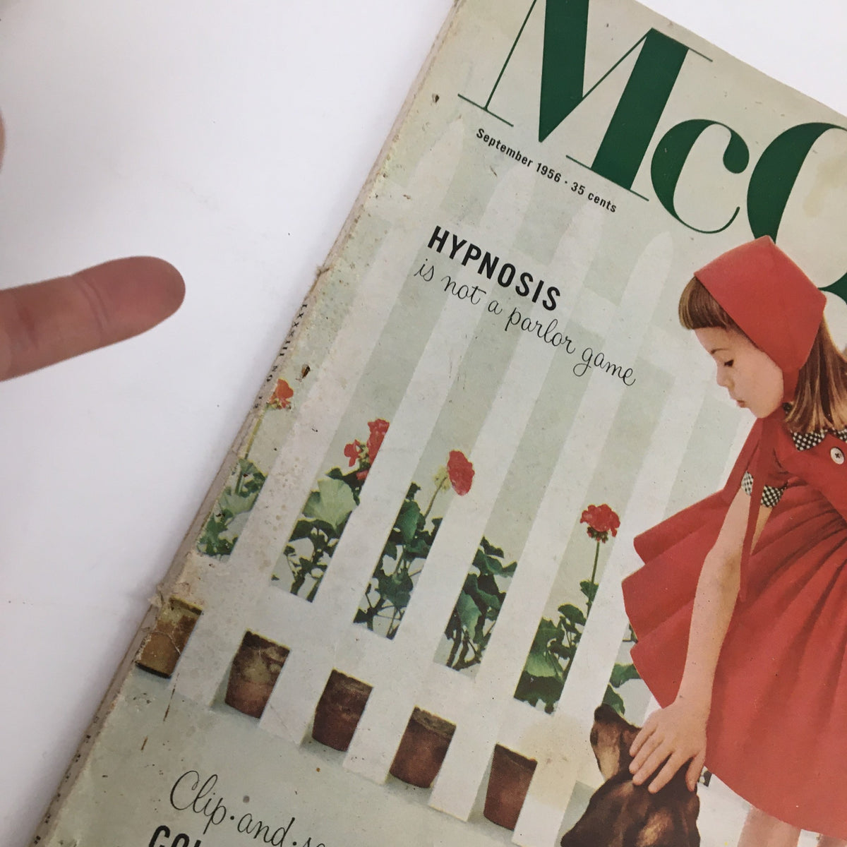 Close-up of McCall's Magazine September 1956 cover, displaying the title and the article on hypnosis, with a young girl in a red dress and a dog.