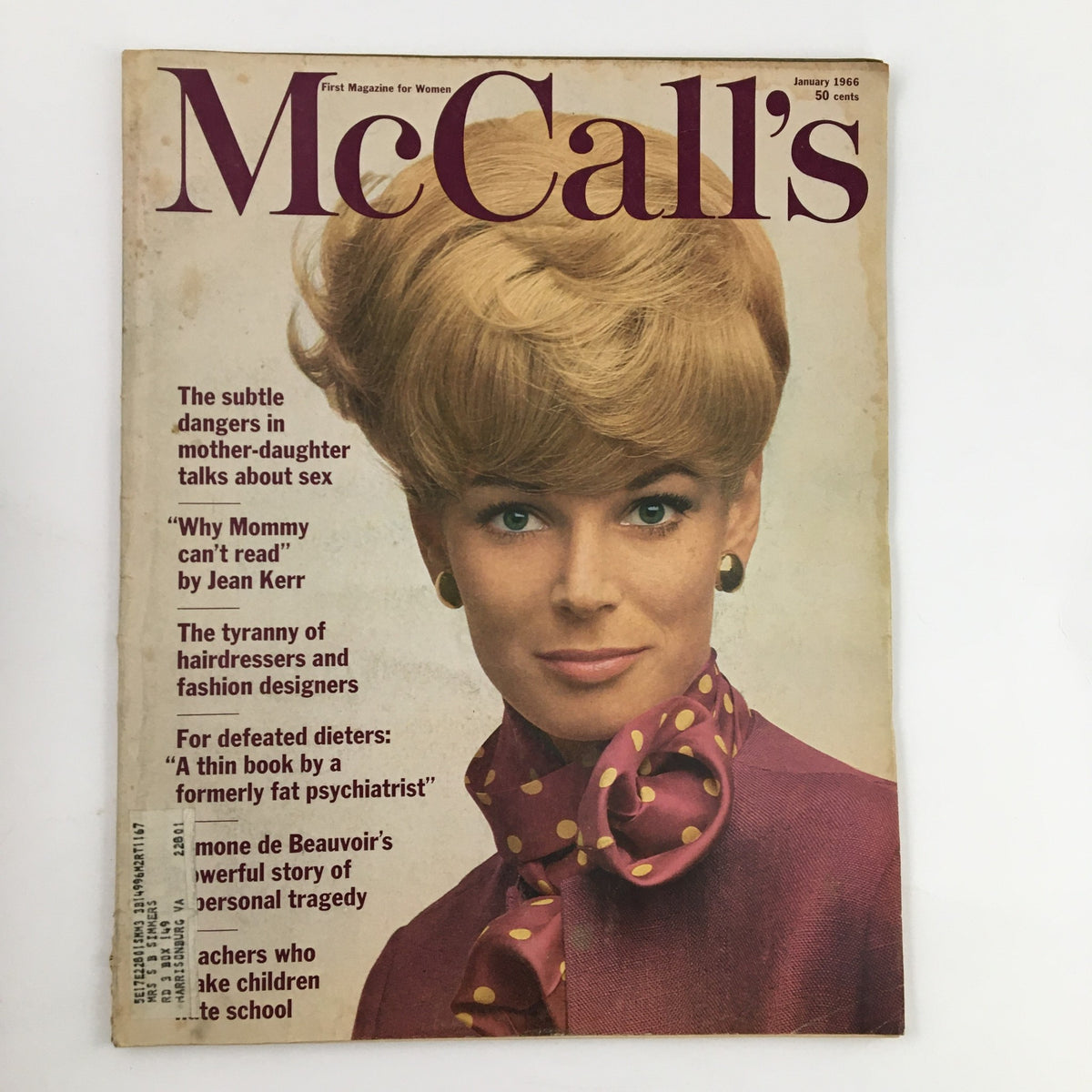 Cover of McCall's Magazine January 1966 featuring a woman with blonde hair styled in a bouffant, wearing a polka dot bow tie, highlighting fashion trends of the 1960s.