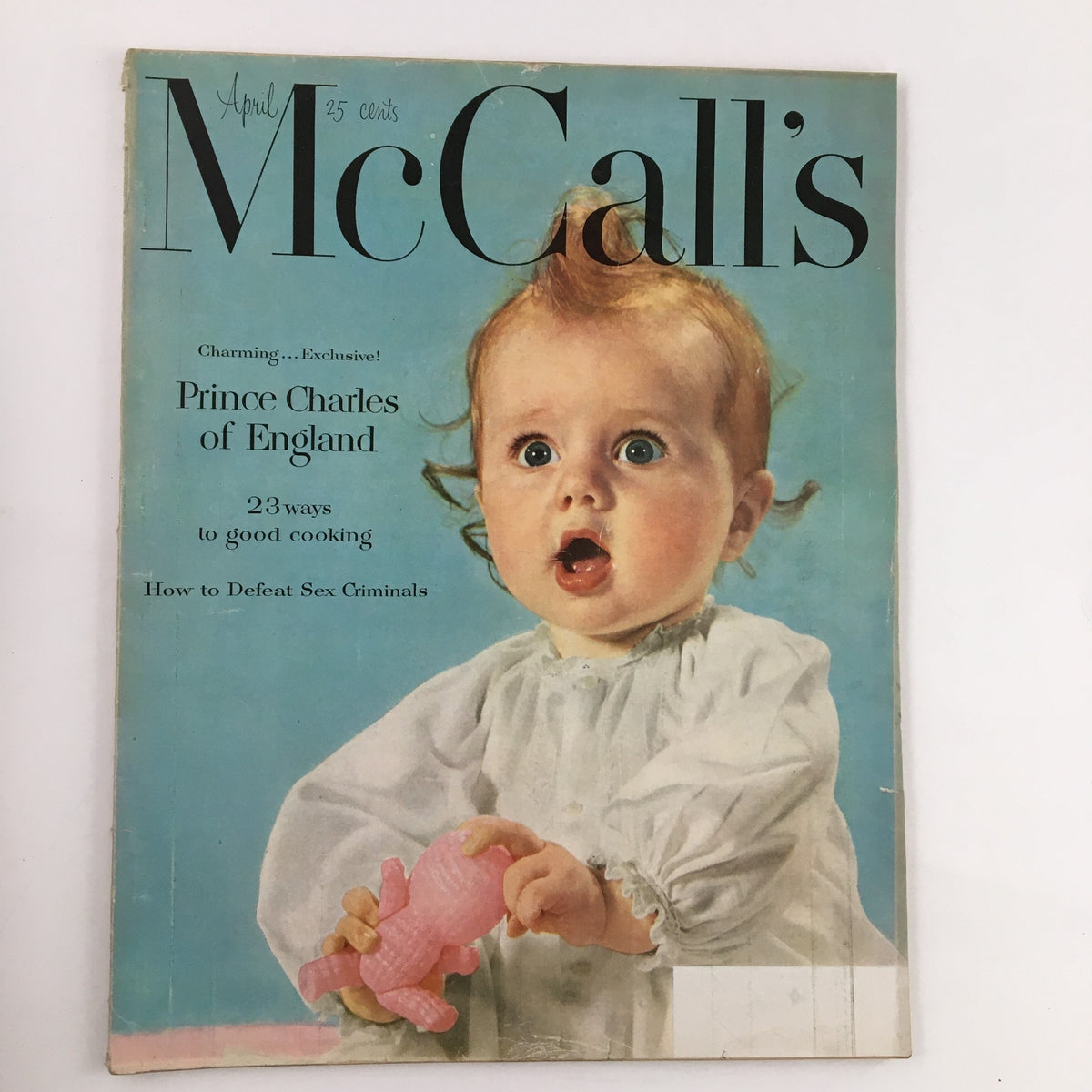 Cover of McCall's Magazine April 1952 featuring a charming baby with a pink toy, advertising Prince Charles of England. This vintage magazine showcases the culture and style of the 1950s.