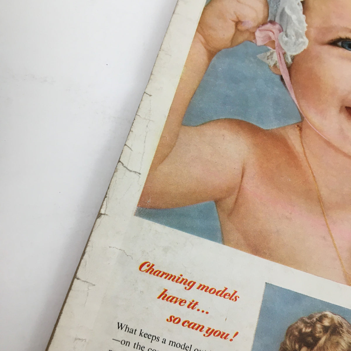 Cover detail of McCall's Magazine April 1952 featuring a charming baby model with a caption about charming models.