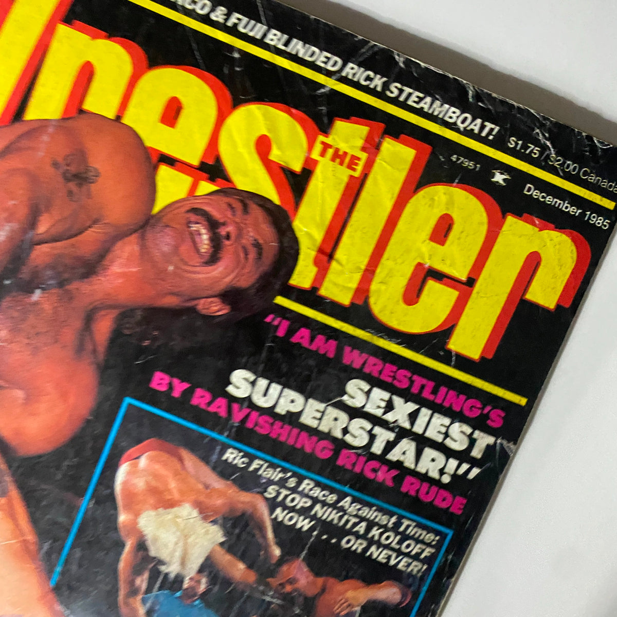 Close-up of The Wrestler Magazine December 1985 cover, focusing on Rick Rude with vibrant title text emphasizing his status in wrestling.