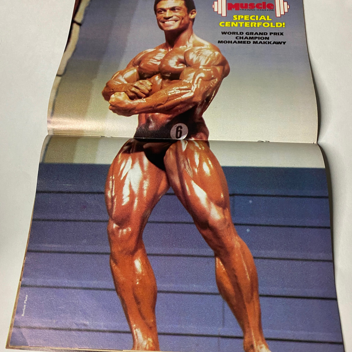 Muscle Training Illustrated January 1985 No. 119 featuring World Grand Prix Champion Mohamed Makkawy in a striking pose on the centerfold, showcasing his impressive physique and muscle definition.
