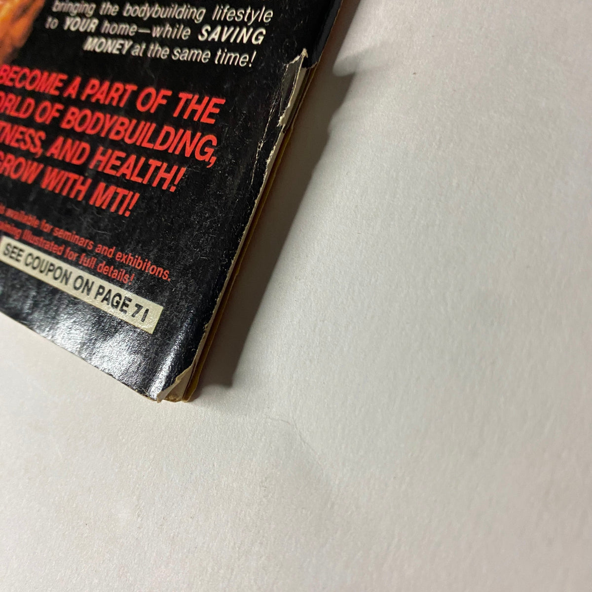 Side view of the back cover of Muscle Training Illustrated April 1984, No. 113, highlighting details about subscription offerings and bodybuilding lifestyle.