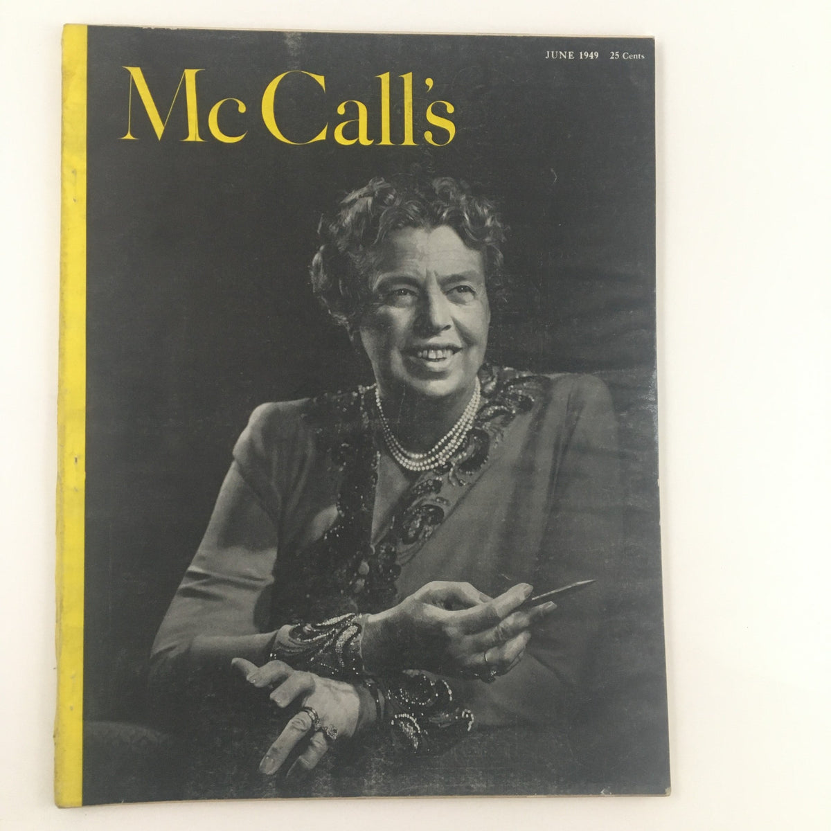 Cover of McCall's Magazine June 1949 featuring a smiling woman adorned with jewelry, showcasing the vintage style and charm of mid-century publications.